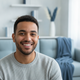 Headshot of a smiling young man, representing a happy, trustworthy customer.