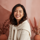 Close-up portrait of a smiling young woman, conveying trust and happiness.